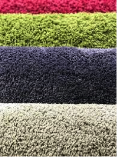 4 carpet samples, red, green, purple and off-white.
