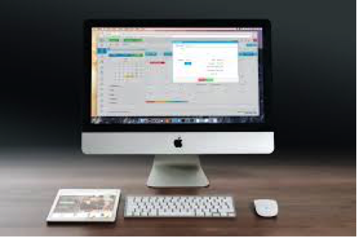 Desktop mac computer. ipad, keyboard and mouse.